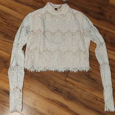 Long Sleeve Delicate Lace Top. Arms Are Sheer Lace. Back Is Open With Two Buttons Around The Neck. Is A Crop Top. White Stretch Feminine Crop Top, Tops Long Sleeve, Lace Back, Sheer Lace, Cream White, Long Sleeve Top, Lace Top, Long Sleeve Tops, Sleeve Top