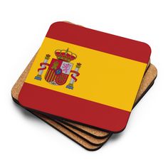 three square coasters with the flag of spain