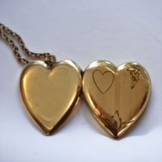 This antique Art Deco heart-shaped locket is crafted with the quality of a bygone era, making it a timeless piece of jewelry for anyone to enjoy. It's the perfect sweetheart gift and a beautiful keepsake of memories that will last a lifetime. This locket and chain with a beautiful art deco engraved front measures about 1 inch across I don't see any stamps or plating wear on this locket I would estimate it to be around 100 yrs old . Brass Heart Pendant Wedding Jewelry, Brass Heart Pendant Jewelry For Wedding, Heart-shaped Brass Jewelry For Wedding, Elegant Brass Heart Necklace, Heart-shaped Brass Wedding Jewelry, Brass Heart Pendant Jewelry For Anniversary, Elegant Heart-shaped Brass Necklace, Brass Heart Charm Jewelry For Gift, Elegant Brass Heart-shaped Jewelry