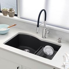 a kitchen sink with two bowls on the counter next to it and a window in the background