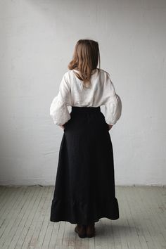 Victorian style inspired long skirt is made from 100% soft and washed linen. Wear it with belt or without. Match it with our tunics! Details: - Composition: 100% Oeko-Tex certified linen - Colour: black - Ruffled skirt - Comes with the belt - Pockets - Elastic waist - Medium weight linen - Linen care: machine wash gentle; tumble dry low, ironing optional - The price is for one skirt, other pictured items are not included Long Black Tiered Skirt Outfit, Full Length Black Lined Skirt, Linen Tiered Skirt, Peasant Style Relaxed Fit Lined Skirt, Elegant Linen Tiered Skirt, Elegant Tiered Linen Skirt, Peasant Long Lined Skirt, Bohemian Linen Bottoms With Relaxed Skirt, Bohemian Linen Bottoms With Relaxed Skirt Fit