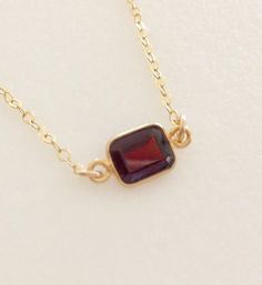 Lovely burgundy red natural garnet gemstone set in 24k gold vermeil bezel. Pendant is 5 x 7 mm and suspended from delicate sparkling 14k gold fill cable chain with matching spring ring clasp. Available in several lengths. Beautiful minimalist necklace makes lovely gift for a January birthday or Valentine sweetheart! Amber Garnet Jewelry As Gift, Amber Garnet Jewelry Gift, Amber Garnet Jewelry For Gift, Formal Garnet Jewelry With Bezel Setting, Formal Burgundy Gemstone Jewelry, Dainty Garnet Gemstone Jewelry, Gold Garnet Birthstone Necklace, Gold Garnet Jewelry With Bezel Setting, Yellow Gold Garnet Birthstone Jewelry