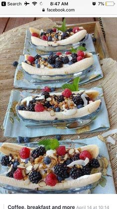 three plates with bananas, berries and nuts on them