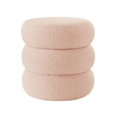 three pink round cushions stacked on top of each other in front of a white background