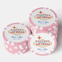 three pink poker chips with the las vegas sign on them