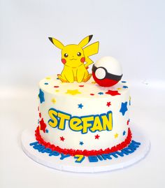 a pokemon themed birthday cake with a pikachu and pokeball topper on it