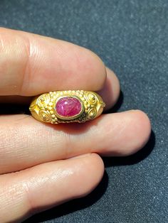 A beautiful gold ring from south east Asia very good condition A beautiful small Ruby light stone is placed in this gold ring The weight of the ring is 4.62 grams we can provide gold certificate as well on request of customers The percentage of gold of this ring is 75 percent which means 18 karat gold we provide fast and free shipping to our customers by which can get the items by maximum 7 working days Gold Dome Cabochon Ring In 14k Gold, 14k Gold Engraved Ring With Gemstone, Traditional Ruby Ring In Yellow Gold, Fine Jewelry Cabochon Ruby Ring In Yellow Gold, Fine Jewelry Ruby Ring In Yellow Gold With Cabochon, Exquisite Yellow Gold Ruby Ring, Gold Oval Dome Ring With Gemstone, Heirloom Gold Signet Ring With Gemstone, Cabochon Ruby Ring In Yellow Gold