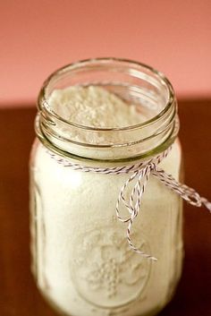 a jar filled with white powder on top of a wooden table