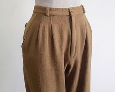 Vintage Brown Tapered Leg Pants - Fabric : 100% wool - Nylon zipper on the front - Pockets - Lined - Made in Japan - Very good vintage condition Measurements : Waist : 25" Hips : 40" Front rise : 12" Back rise : 15" Inseam : 24" Total length : 34.5" Width of hem : 14" Our products are vintage clothing that will be cleaned so you can be confident in the quality. We carefully inspect each garment to make sure that you get the most accurate and informed description possible. We do our best to state any imperfections in the listing. If a flaw accidentally escapes our inspection, please let me know as soon as possible and we will be happy to help remedy the situation. Please read the product description carefully before purchasing to ensure it meets your needs. If you have any questions, please Fitted Wool High Waist Bottoms, Fitted High Waist Wool Bottoms, Fitted Wool High-waisted Bottoms, High-waisted Wool Pants In Brown, High-waisted Brown Wool Pants, Brown Wool High-waisted Pants, Fitted High Waist Wool Pants, Tailored High Waist Wool Pants, High Waist Wool Pants For Fall