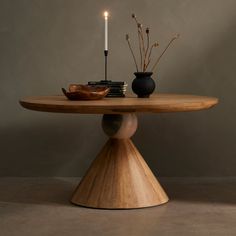 a wooden table with two candles on it