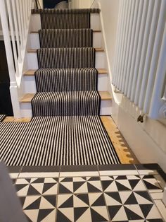 a black and white striped carpet on the stairs