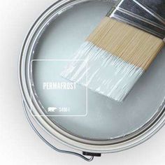 a paint can with a brush in it