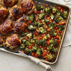 chicken and broccoli on a tray with spoons