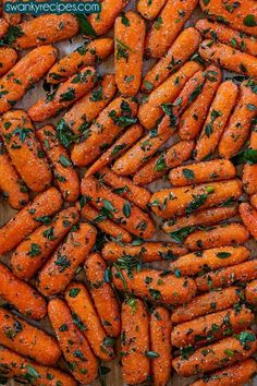 there are many carrots that have been cooked and garnished with parsley