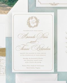 the wedding stationery is laid out on top of each other, including two envelopes and