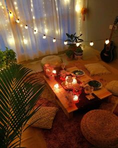 a living room filled with lots of furniture and candles on top of a wooden table