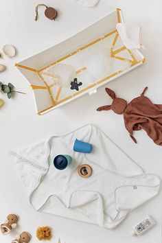 an assortment of baby items laid out on a white table with the contents in it