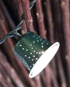 a green and white lamp hanging from a wire