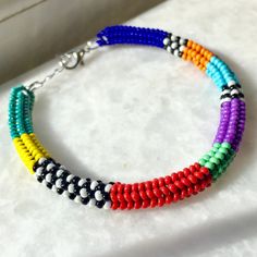 This handmade beaded woven bracelet is carefully hand-woven from the highest quality glass seed beads! Boho style bracelet in vibrant colors sits elegantly on your wrist thanks to its stainless steel extension chain. Multicolor beaded bracelet, compatible with all your clothes that you can use in all seasons, is the ideal handmade gift accessory for you and your loved ones! Unique bracelet guaranteed to get all the compliments! You can click the link for my other handmade jewelry and accessories Multicolor Tiny Beads Braided Bracelets For Friendship, Multicolor Braided Bracelets With Tiny Beads For Beach, Multicolor Braided Bracelets With Tiny Beads For Friendship, Multicolor Hand-strung Braided Bangle Bracelet, Multicolor Heishi Beads Friendship Bracelets, Multicolor Beaded Braided Bracelet For Beach, Handwoven Multicolor Braided Bracelets, Beach Multicolor Beaded Braided Bracelet, Multicolor Beaded Braided Bracelets