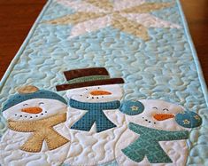 a table runner with snowmen on it