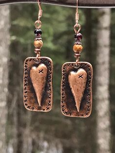 Unique copper heart earrings with Garnet and picture jasper gemstones. You will love these antique copper steam punk heart earrings! Garnet is the stone of love, and it is the perfect complement to the picture jasper stone. These earrings are 2 inches long and 5/8 of an inch wide. They are slightly heavier than most of my other earrings, but not too heavy. Weight is 3.8 grams. The French ear wires are solid copper. All my jewelry comes gift boxed with a custom Shelly Mariposa Design butterfly ca Artisan Rust-colored Earrings As Gift, Vintage Handmade Rust Jewelry, Soldered Copper Earrings As A Gift, Bohemian Metal Heart Earrings As Gift, Hand Forged Brown Earrings As A Gift, Handmade Rust Earrings For Gift, Vintage Hand Forged Copper Earrings, Bohemian Style Heart Earrings As A Gift, Handmade Bronze Jewelry For Valentine's Day