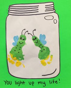 a child's drawing of two green caterpillars in a jar with the words you light up my life