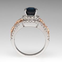 This gorgeous 18K white and rose gold ring is centered with one (1) emerald cut natural sapphire weighing 2.71 carats that is set into a four-prong setting. The top half of the ring is accented with one hundred two (102), prong set, round brilliant cut diamonds. The ring measures 12.0mm at the top, rises 9.5mm above the finger, tapering to 3.1mm wide and 1.3mm thick at the base of the shank. It is currently a size 5.75. Luxury Sapphire Ring With Emerald Cut And Accent Stones, Luxury Emerald Cut Sapphire Ring With Diamond Detail, Exquisite Emerald Cut Sapphire Ring, Exquisite Emerald-cut Sapphire Ring, Elegant Emerald Cut Sapphire Ring With Center Stone, Elegant Octagon Sapphire Ring With Center Stone, Elegant Octagon Sapphire Ring With Brilliant Cut, Elegant Octagon Diamond-cut Sapphire Ring, Elegant Octagon Diamond Cut Sapphire Ring