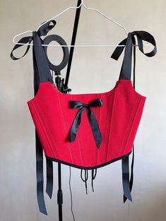 Red corset top with black elements❤️🖤  *The straps are cut with a stitch and tied with bows🎀  *There is a black satin bow in the centre *There is a seam along the lines, an ornament in the form of leaves  *the corset has a cotton lining the corset is made in one copy ✅ Fits this size: for bust 33.1-35.8 inch (84-91cm)  waist 24.8-26.8 inch (63-68 cm) Elegant Red Corset Belt For Party, Party Underbust Corset Belt With Straps, Black Corset With Straps For Costume Party, Party Underbust Corset Belt, Underbust Corset Belt With Straps For Night Out, Red Sleeveless Boned Bodice Corset, Gothic Corset Belt With Straps For Party, Red Underbust Corset For Evening, Red Evening Underbust Corset