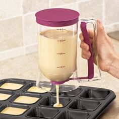 a person is pouring batter into a blender