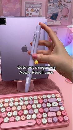 a person holding an iphone in front of a pink keyboard with the caption cute but dangerous apple pencil case