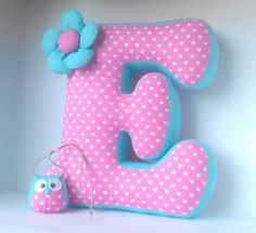 the letter e is decorated with polka dots and a flower