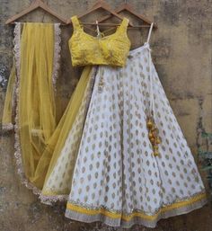 Material : Lehenga - jacquard silk Choli - tapetta silk Work - heavy embroidery work Dupatta - soft net Occasions : Wedding, Party, Birthday Care instruction : Do not brush hard Indian Designer Lehenga, White Lehenga Choli, Lehenga Choli Designs, Indian Wedding Lehenga, Yellow Lehenga