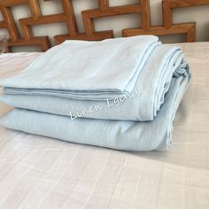 two sheets folded on top of each other on a bed