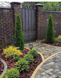 a brick driveway surrounded by trees and shrubbery