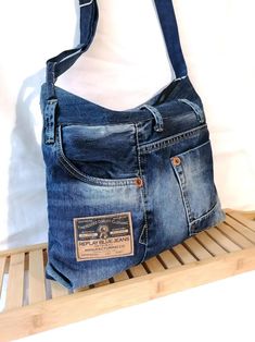 a purse made out of jeans is sitting on a shelf