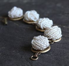 "How cool is this? Pefectly preserved pearly white bead clip on earrings, vintage 50's and 60's, make this a really fun bracelet, that definitely makes people take notice. This is a rich looking bracelet that can be dressed up or down. These earrings are harder to find than I thought they would be. But the hunt sure is fun. 7 1/2\" long. I work with antique and vintage parts. Some may show signs of wear or age. Please look at each picture closely. I have tried to show all aspects of my work. Ple Antique White Pearl Jewelry, Vintage Adjustable Jewelry With Pearl Charm, Vintage Jewelry With Pearl Charm, Vintage Pearl Jewelry With Vintage Charm, Handmade Vintage Cream Bracelets, Vintage Handmade Cream Bracelets, Vintage Pearl White Jewelry For Party, White Pearl Button Jewelry For Party, White Jewelry With Pearl Buttons For Parties