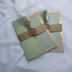 three wedding cards with wax stamping on them are laying next to each other in front of a white sheet