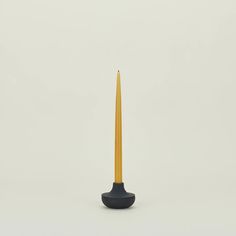 a black and yellow candle holder on a white background