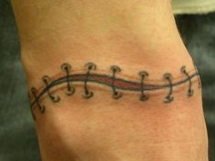 a person with a tattoo on their arm that has musical notes in the middle of it