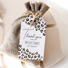 a gift bag with a tag that says, thank you wild time