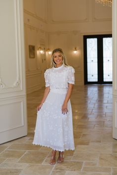 Be effortlessly chic in our Floral Applique Skirt Set! This stunning white set features a round neckline, zipper closures, and a waist tie detail for a flattering fit. The sheer material is adorned with delicate floral appliques and rhinestone accents, adding a touch of elegance. Perfect for any occasion, this high waisted midi skirt set is a must-have for your wardrobe. 100% polyester Top liner included - fully lined skirt Model is 5'6" with a 34" bust, 27" waist, and 36" hips wearing a size sm White Floral Embroidered Skirt For Wedding, White Floral Embroidery Skirt For Wedding, White Floral Embroidered Wedding Skirt, Feminine White Skirt With Floral Embroidery, White Flowy Dress With Lace Trim, Chic White Skirt With Floral Embroidery, White Feminine Skirt For Garden Party, Feminine White Skirt For Garden Party, Chic Floral Embroidery Dress With Flowy Skirt