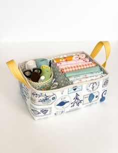 an open storage bag filled with various items on top of a white table next to a wall