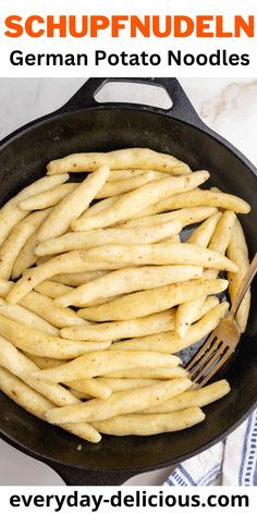 a skillet filled with french fries on top of a table