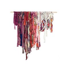 an assortment of scarves hanging from a clothes line