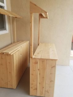 two wooden benches sitting next to each other on a porch near a building with a window