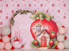 a strawberry themed birthday party with balloons, cake and decorations on the table in front of pink wallpaper