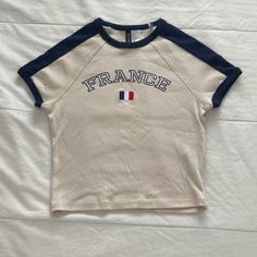 H&M “France” Baby Tee. New Without Tags / Has Never Been Worn Before. Size Women’s Small. No Flaws And In Perfect Condition. Cute H&m Crew Neck Top, Cute Cream Tops With Letter Print, H&m Sporty Crew Neck Tops, Sporty H&m Crew Neck Tops, Sporty Spring Tops By H&m, Sporty Spring Tops From H&m, Sporty H&m Tops For Spring, Sporty Cream Tops With Letter Print, Blue Crew Neck Tops By H&m