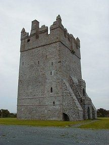 an old stone castle with a steeple on the side