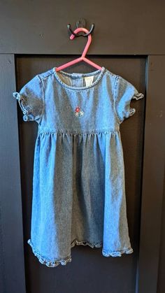 Please Double check the size listed for the item, as we do not accept returns. Please reach out with any questions you have! Thanks for shopping with us!  Absolutely darling vintage 1990s baby girls denim dress. This is in wonderful condition with no stains! It has sweet little flower embroidered into the front of the dress. The tag says it is 100% cotton and that it is size 18 months. I do believe that it could go to 18-24 months.  Do you love vintage and unique items? Check out our shop for mo Cute Short Sleeve Denim Dress, Cute Fitted Cotton Denim Dress, Vintage Denim Dress With Short Sleeves, Girls Denim Dress, New Inventory, Love Vintage, Girls Denim, Cotton Baby, Unique Items