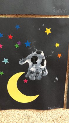 a child's drawing of a dog on the moon and stars